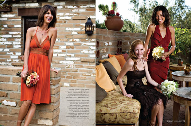 Three women in elegant dresses pose by a rustic brick patio, surrounded by greenery and warm outdoor decor—a scene worthy of Exquisite Weddings Magazine. They smile and hold bouquets, one standing while the others sit on a cushioned bench.