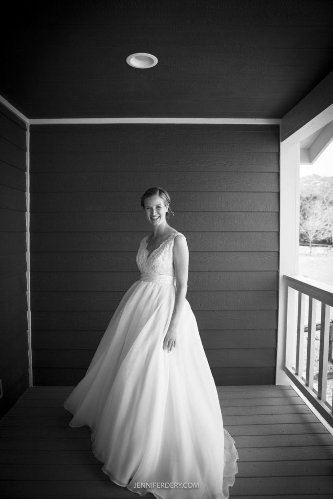 beautiful bride in long white dress on porch in black and white