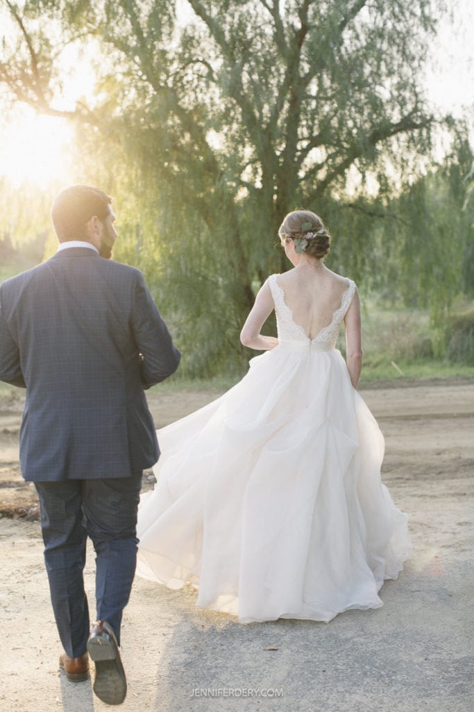 bride and groom walking into a tree grove rustic wedding on a farm in temecula, ca